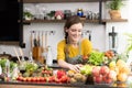 Healthy young woman in a kitchen preparing fruits and vegetables for healthy meal and salad Royalty Free Stock Photo