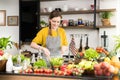 Healthy young woman in a kitchen preparing fruits and vegetables for healthy meal and salad Royalty Free Stock Photo