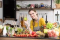 Healthy young woman in a kitchen preparing fruits and vegetables for healthy meal and salad Royalty Free Stock Photo