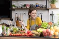 Healthy young woman in a kitchen preparing fruits and vegetables for healthy meal and salad Royalty Free Stock Photo