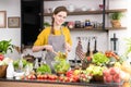 Healthy young woman in a kitchen preparing fruits and vegetables for healthy meal and salad Royalty Free Stock Photo