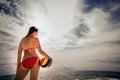 Healthy young woman laughing with beach ball while on the beach in summer Royalty Free Stock Photo