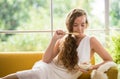 Woman lying on a couch holding a bowl of yogurt Royalty Free Stock Photo