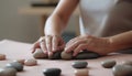 Healthy young woman massaging hand with pebble for alternative therapy generated by AI