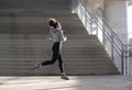 Healthy young woman running in urban environment Royalty Free Stock Photo