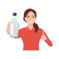 Healthy young woman showing bottle of mineral water and give thumb up Royalty Free Stock Photo