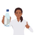 Healthy young woman showing bottle of mineral water and give thumb up