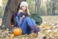 Healthy young woman sitting by the tree holding fruits and vegetables Royalty Free Stock Photo