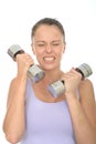 Healthy Young Woman Training With Dumb Bell Weights Looking Strained