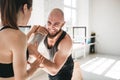 Fit female athlete doing stretching with male trainer