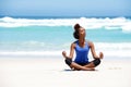 Healthy young yoga woman meditating at the beach Royalty Free Stock Photo