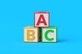 Heap of ABC cubes on blue background. Letter blocks for preschool education. Learning alphabet Royalty Free Stock Photo