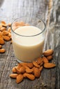 Heap of almonds and a glass of almond milk