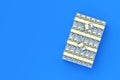 Heap of american dollars. Stack of money on blue background