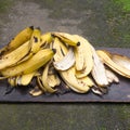 Heap of banana peels on a wooden tray