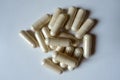Heap of beige capsules of Saccharomyces boulardii probiotic from above