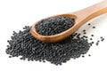 Heap of black organic beluga lentils in wooden spoon on white