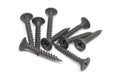 Heap of black steel screws on white background Royalty Free Stock Photo