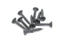 Heap of black steel screws on white background Royalty Free Stock Photo