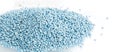 Heap of blue chemical fertilizer on white