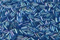 Heap of blue cylindrical bead