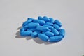 Heap of blue oval pills as a symbol of medicine, healing and pharmacy Royalty Free Stock Photo