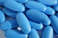 Heap of blue oval pills as a symbol of medicine, healing and pharmacy Royalty Free Stock Photo