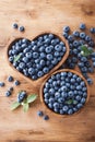 Heap of blueberry in bowl on wooden rustic table top view. Organic superfood and healthy berry Royalty Free Stock Photo