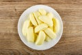 Heap of candies in shape of bananas in plate on table. Top view