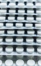 Heap of Capsules packed in blisters, round patterned shaped medicine tablet or antibiotic pills. Medical Pharmacy theme. Close up