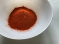 A heap of Chilly powder in a bowl on an isolated white background Royalty Free Stock Photo