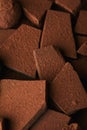 Heap of chocolate bars in cocoa powder