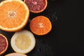 Heap of citruses and juice glass on black background Royalty Free Stock Photo