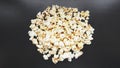 Heap of classic salty popcorn on black background. Concept cinema or food