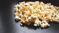 Heap of classic salty popcorn on black background. Concept cinema or food