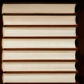 Heap of closed books in hard covers on dark background