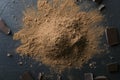 Heap of cocoa powder and pieces of broken chocolate br on the dark surfac, top view Royalty Free Stock Photo