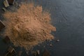 Top view of cocoa powder heap and crushed chocolate bar. Pieces of chocolate bar and cocoa powder on the dark table.Empty space Royalty Free Stock Photo