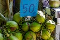 Coconuts for sale on a Thailand street, priced at 50 baht each Royalty Free Stock Photo