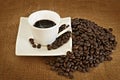 Heap of coffee beans and coffee cup