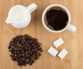 Heap of coffee beans, hot drink and jug milk Royalty Free Stock Photo