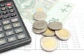 Heap of coins, paper money and calculator on spreadsheet Royalty Free Stock Photo