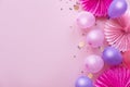 Heap of colorful balloons, confetti and paper flowers on pink table top view. Birthday party background. Festive greeting card.