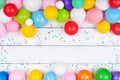 Heap of colorful balloons and confetti on white table top view. Festive or party background. Flat lay. Birthday greeting card Royalty Free Stock Photo