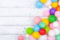 Heap of colorful balloons and confetti on white table top view. Festive or party background. Flat lay. Birthday greeting card Royalty Free Stock Photo