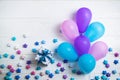 Heap of colorful balloons on white wooden background. Birthday or party background. Flat lay style Royalty Free Stock Photo