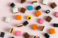 Heap of colorful Liquorice allsorts on pink background. Sweets Royalty Free Stock Photo