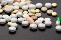 Heap of colorful medication on black background Royalty Free Stock Photo