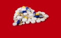 Heap of colorful pills in the shape of a heart, tablets and capsules onwhite background. Drug prescription for treatment