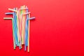 Heap of colorful plastic drinking straws on Colored background, flat lay. Copy Space for text Royalty Free Stock Photo